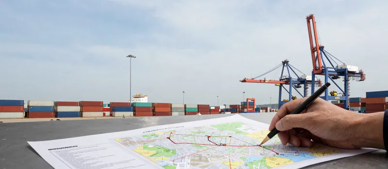 Shipping route being planned on a map at a container port